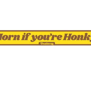 May include: A yellow and brown bumper sticker with the text "Horn if you're Honky!" and the text "Death Trap" in smaller font below.