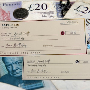 May include: A mock cheque made out to Brad Pitt for two hundred pounds, dated 19-01-2025. The cheque is from the Bank of Kim, located at 17 Cherry Tree Lane. The cheque is for "Your Birthday."
