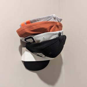 Multiple hats stacked in a hat rack
