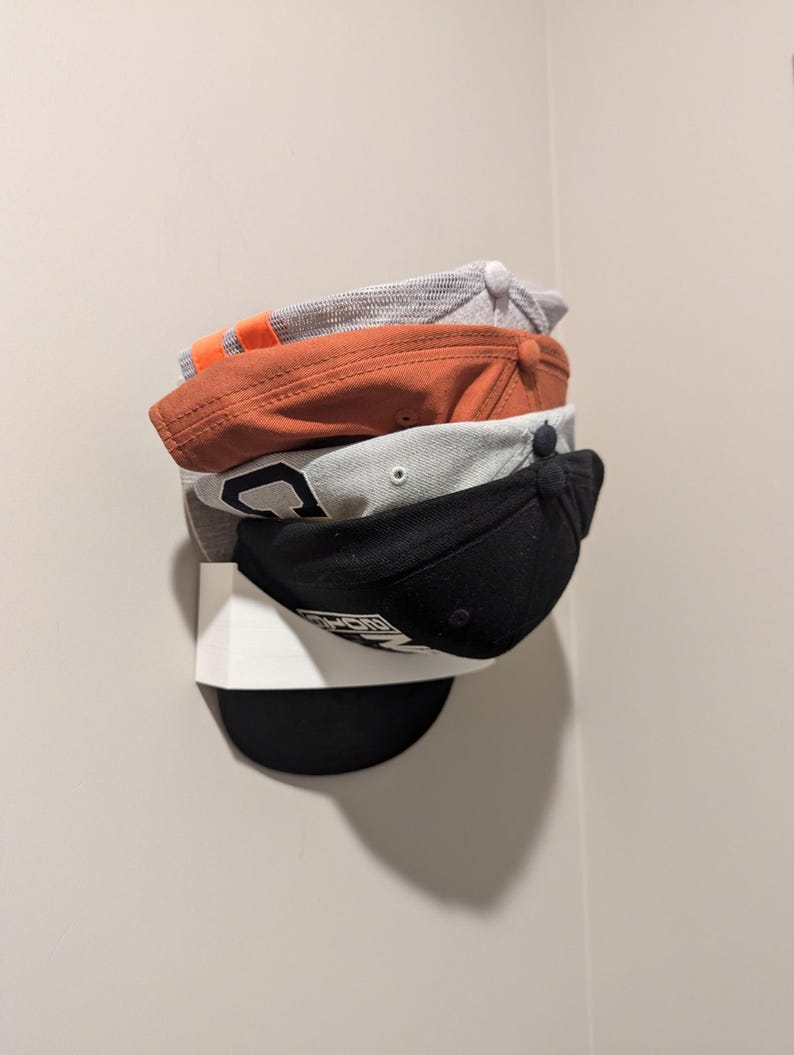 Multiple hats stacked in a hat rack