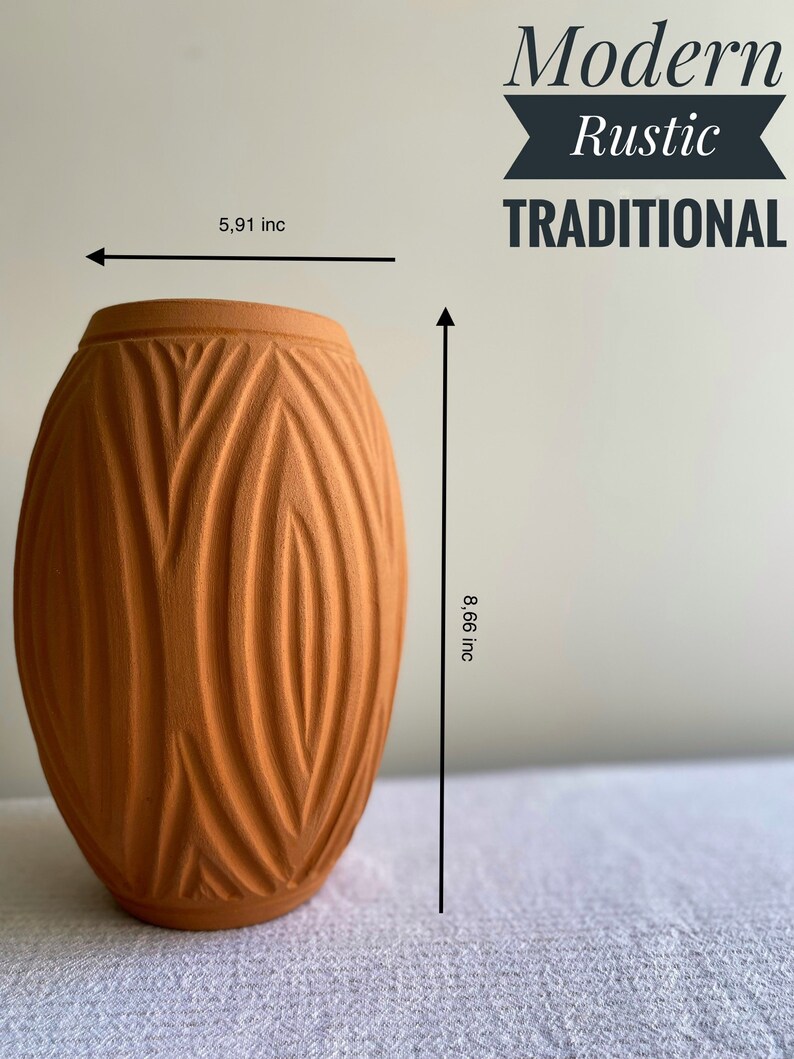 May include: A terracotta vase with a textured, geometric pattern. The vase is 8.66 inches tall and 5.91 inches wide. Modern Rustic Traditional.