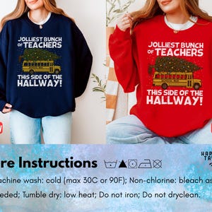 May include: A navy blue sweatshirt and a red sweatshirt, each featuring a graphic of a yellow school bus carrying a decorated Christmas tree on its roof. The text reads: JOLLIEST BUNCH OF TEACHERS THIS SIDE OF THE HALLWAY! The shirts have long sleeves.