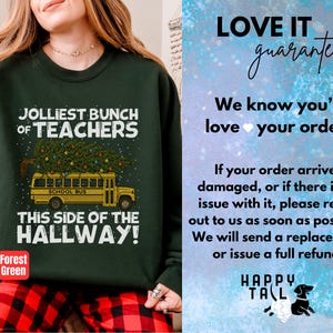 May include: A forest green sweatshirt featuring a graphic of a yellow school bus carrying a decorated Christmas tree on its roof. The text reads JOLLIEST BUNCH OF TEACHERS THIS SIDE OF THE HALLWAY. The sweatshirt is paired with red and black plaid pants.