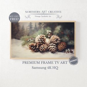May include: A painting of a group of pine cones on a snowy surface with pine branches and berries. The background is a blurred forest scene. The painting is framed in a light wood frame.