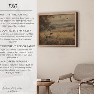 May include: A framed vintage-style print depicting a hunting scene with a dog in a field. The artwork features a dog, trees, and a landscape in muted tones. The frame is a light brown color. The image is displayed on a wall.