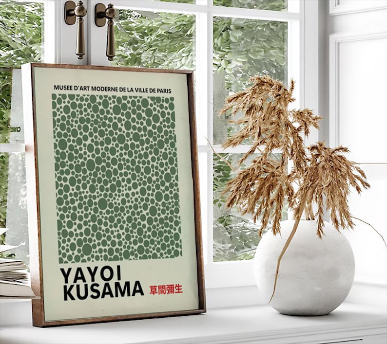 May include: A framed print of a green polka dot pattern with the text "MUSEE D'ART MODERNE DE LA VILLE DE PARIS" at the top and "YAYOI KUSAMA 草間彌生" at the bottom.