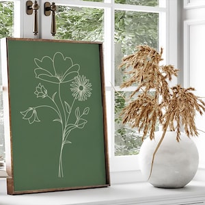 May include: A framed print with a green background and a white line drawing of a bouquet of flowers. The flowers include a large bloom, a smaller bell-shaped flower, and a daisy.