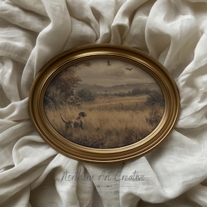 May include: Oval framed print featuring a sepia-toned hunting scene with a dog, hunter, and birds in flight. The gold frame surrounds the artwork, set against a neutral fabric backdrop. The text "Northern Art Creative" is visible at the bottom.