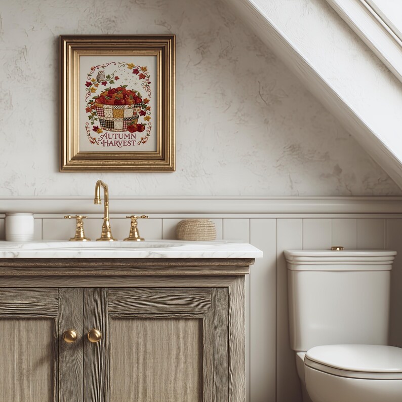 May include: A framed wall art print titled Autumn Harvest featuring a basket of red apples, colorful fall leaves, and a small owl. The artwork is displayed in a gold-toned frame with a decorative border, showcasing a seasonal theme with warm colors.