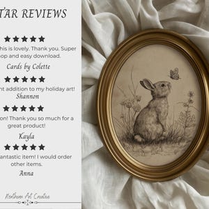 May include: An oval framed print featuring a detailed pencil sketch of a rabbit gazing at a butterfly. The artwork is set against a neutral background and framed in a gold-colored frame. The text "5 STAR REVIEWS" is at the top.