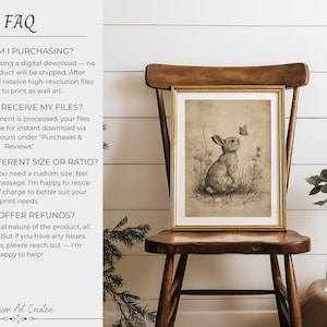 May include: A framed vintage-style print of a rabbit and butterfly. The artwork is in a gold frame and is displayed on a wooden chair. The image has the text "FAQ" and "Northern Art Creative".