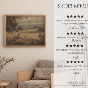 May include: A framed landscape painting with a dog in a field, in a room with a chair and table. The painting has a wooden frame and depicts a dog in tall grass, with trees and a cloudy sky in the background. Text on the right reads "5 STAR REVIEWS".