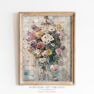 May include: A framed print featuring a floral arrangement under a shower head. The artwork showcases a variety of flowers in shades of pink, purple, yellow, and white, with water cascading over them. The frame is a light gold color.