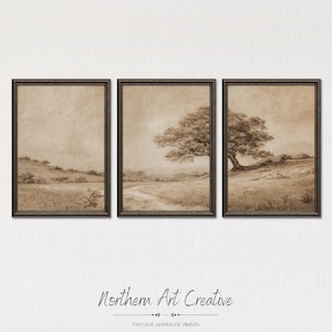May include: A triptych of three framed wall art prints featuring a sepia-toned landscape illustration of rolling hills, a dirt path, and a large tree. The artwork is presented in dark brown frames with a textured, aged paper appearance.