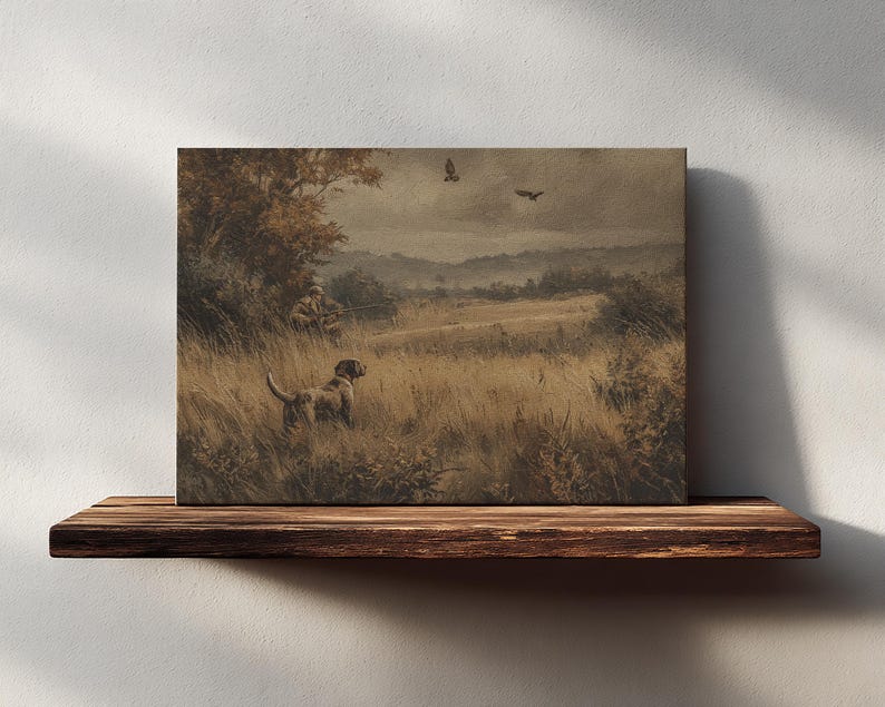 May include: A sepia-toned canvas print depicting a hunting scene. A dog stands in tall grass, with a hunter in the background. Two birds fly overhead. The artwork is displayed on a rustic wooden shelf against a white wall.