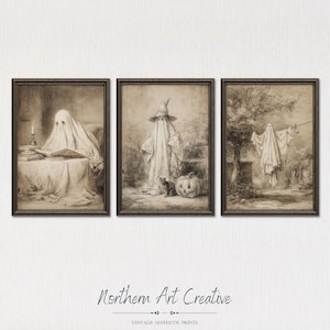 May include: A set of three sepia-toned art prints in dark frames. The first shows a ghost reading at a table. The second depicts a ghost in a pointed hat standing with a cat and a pumpkin. The third features a ghost hanging on a clothesline.