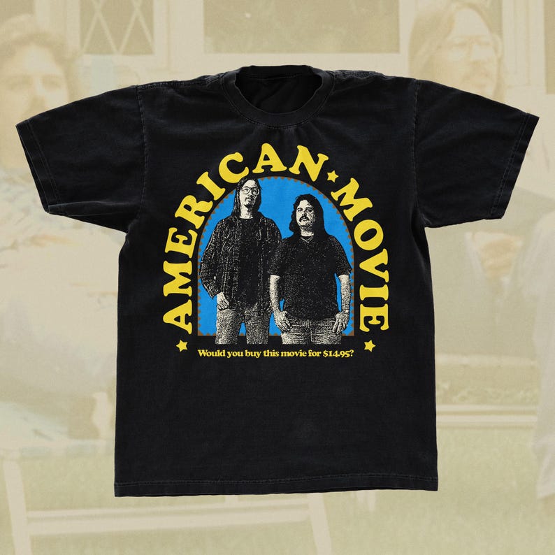 May include: Black t-shirt with a yellow and blue graphic of two men with the text "AMERICAN MOVIE" and "Would you buy this movie for $14.95?"
