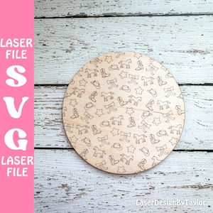 May include: A round wooden plaque with a repeating pattern of cowboy boots, horses, stars, and bows. The design is in black and white.