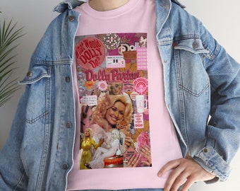 May include: Pink t-shirt with a collage of images featuring Dolly Parton, including a photo of her with a kitten, a disco ball, and the text "What Would Dolly Do?" and "Dolly Parton".