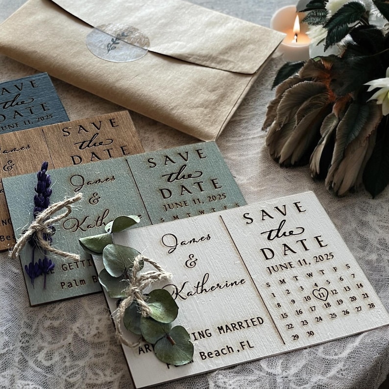 May include: Four wooden save the date cards with a rustic design. The cards are decorated with greenery and flowers. The text on the cards reads "Save the Date" and includes the names "James & Katherine" and the date "June 11, 2025".