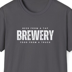 May include: A dark gray t-shirt with a white distressed graphic that reads "Beer from a tap Brewery Food from a truck".