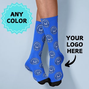 May include: Blue socks with a white logo that says "Logicwave Systems" and a headphone icon. The text "Your Logo Here" is written on the image.