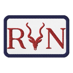 May include: A white patch with a navy blue border. The patch has the letters "RVN" in red with a red stylized antelope head between the "V" and "N".