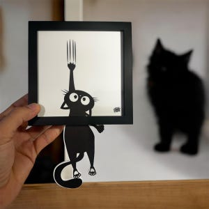 Our little black cat slips out of the frame to invite you to think differently... Original illustration + frame, signed Funky Frames.