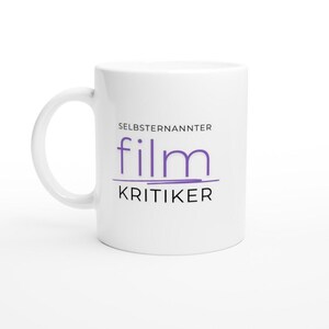 May include: White ceramic mug with a purple and black design that says "Selbsternannter film Kritiker".