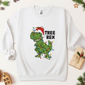 a t - shirt with a dinosaur wearing a christmas hat