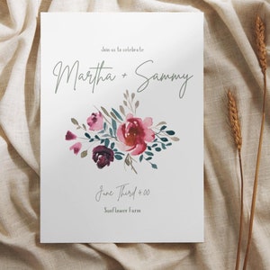 May include: Wedding invitation with a watercolor floral design in shades of pink, purple, and green. The invitation reads "Join us to celebrate Martha + Sammy June Third 4:00 Sunflower Farm".