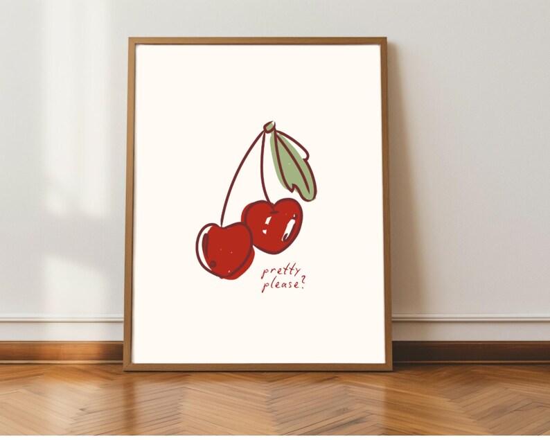 Puede incluir: Una impresi&oacute;n art&iacute;stica enmarcada con una ilustraci&oacute;n caprichosa de dos cerezas rojas con hojas verdes. La frase "pretty please?" est&aacute; escrita debajo de las cerezas en un estilo manuscrito. La obra de arte est&aacute; sobre un fondo crema.