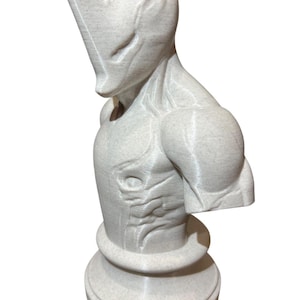 May include: A light gray, 3D-printed sculpture of a humanoid alien bust. The sculpture features a detailed design with a textured surface, prominent shoulders, and a slender, elongated head. The bust is mounted on a circular base.