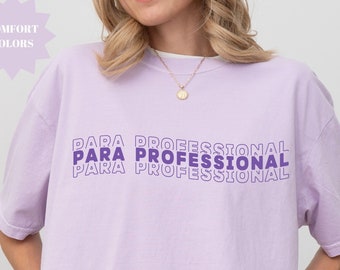 May include: A lavender colored t-shirt with the text "PARA PROFESSIONAL" repeated three times in a stacked design in purple.