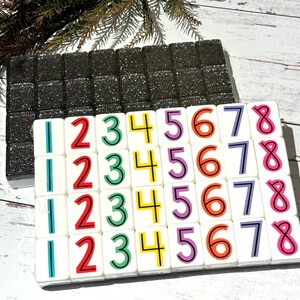 May include: A set of 36 white tiles with colorful numbers 1 through 8. The tiles are arranged in a grid of 6 rows and 6 columns. The numbers are in a bold, black font.