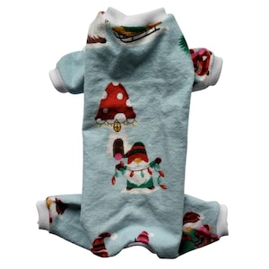 May include: A light blue dog pajamas with a white trim. The pajamas feature a festive gnome and mushroom design.
