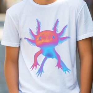 May include: White t-shirt with a colorful axolotl graphic. The axolotl is a pink and blue amphibian with feathery gills.