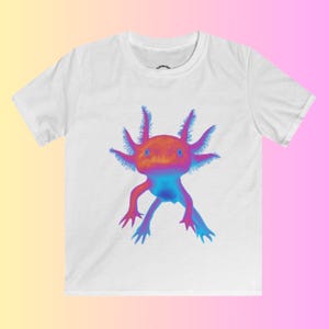 May include: White t-shirt with a colorful axolotl graphic. The axolotl is a pink, blue, and orange amphibian with feathery gills.