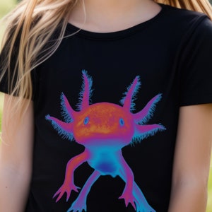 May include: Black t-shirt with a colorful axolotl graphic. The axolotl is a pink and blue amphibian with feathery gills.
