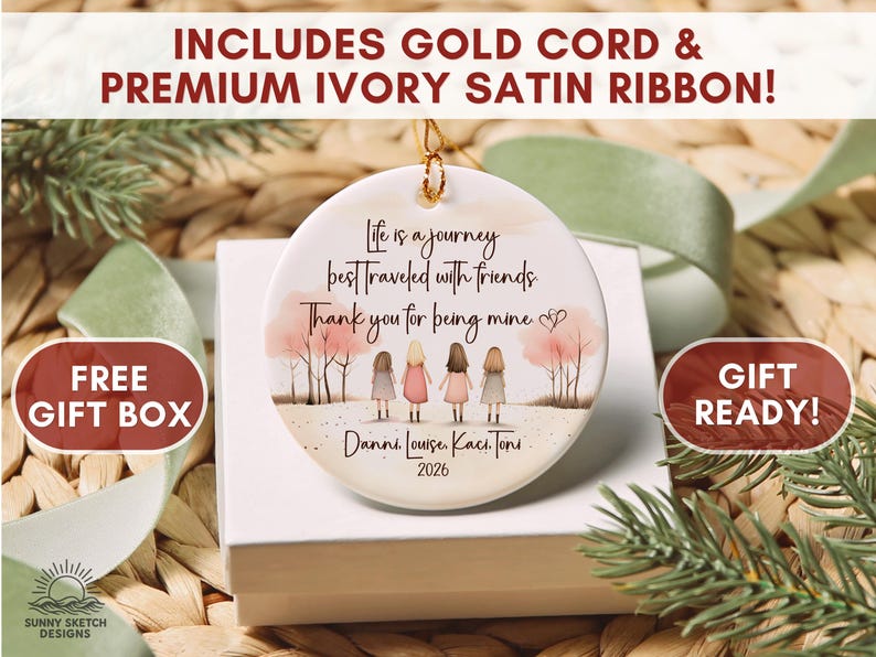 May include: A round white ceramic ornament featuring an illustration of four people standing in a row with pink trees in the background. The text reads: Life is a journey best traveled with friends. Thank you for being mine. Danni, Louise, Kaci, Toni, 2026.
