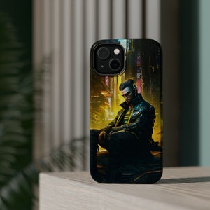 Puede incluir: Una funda de teléfono negra con un diseño cyberpunk que presenta a un hombre con una chaqueta negra y una camisa amarilla y azul sentado en una ciudad futurista.