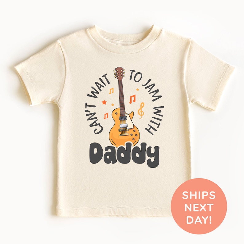 a white shirt with a guitar on it