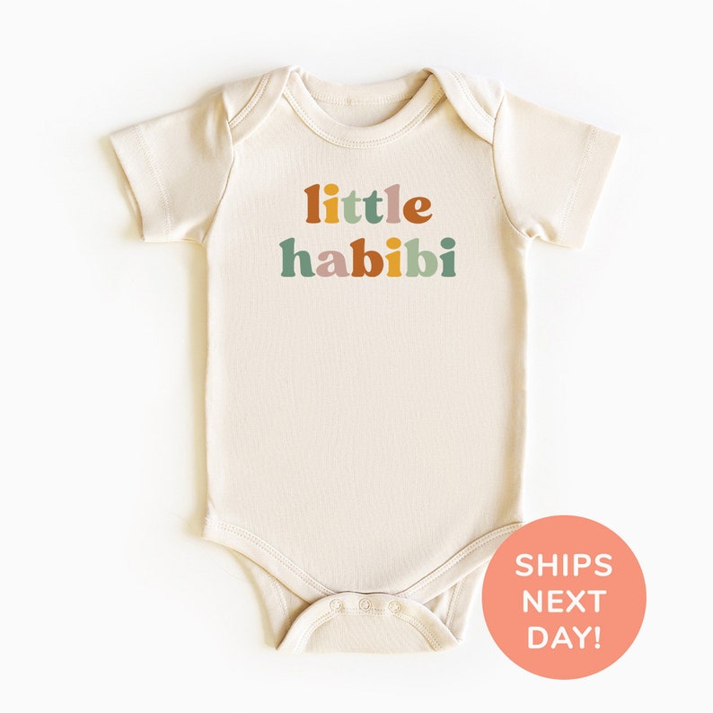 a baby bodysuit with the words little habii printed on it
