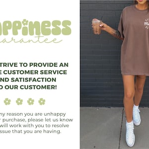 May include: A brown t-shirt with the text "Tired Mama Club" in white. The image also includes the text "happiness guarantee" in green, along with a customer service guarantee. The person is wearing white sneakers.