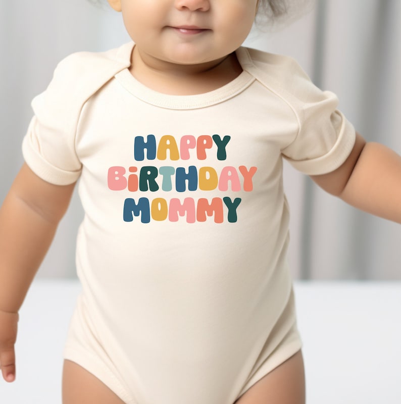 a baby in a bodysuit with the words happy birthday mommy on it