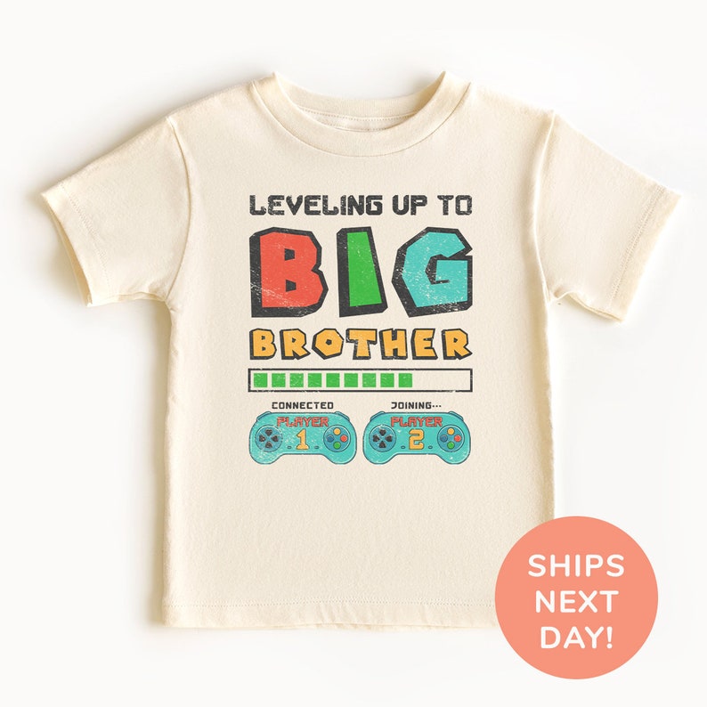 a t - shirt with the words, leveling up to big brother on it