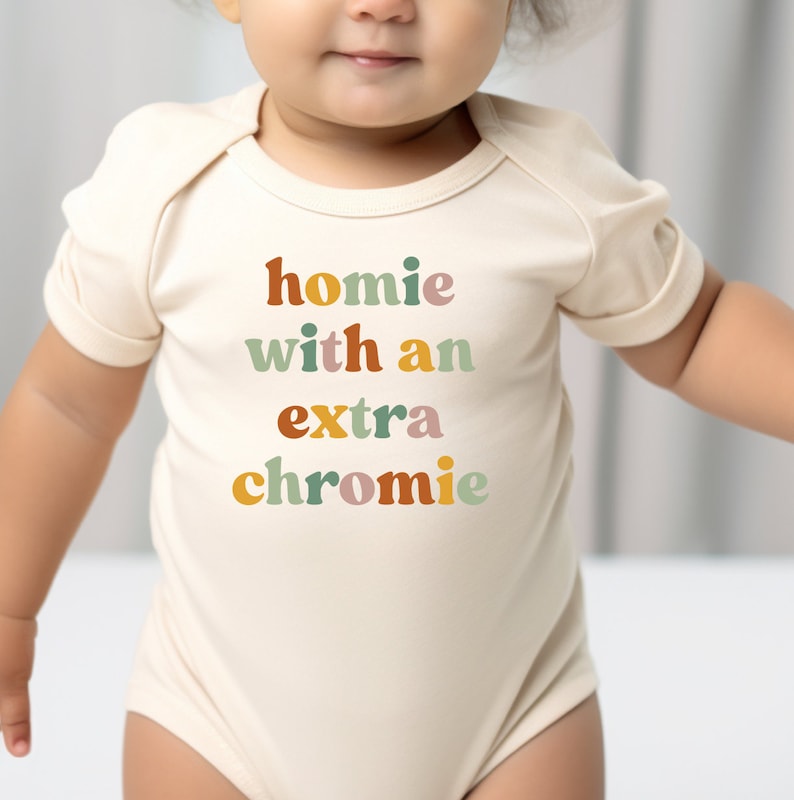 a baby wearing a bodysuit that says, home with an extra chronic