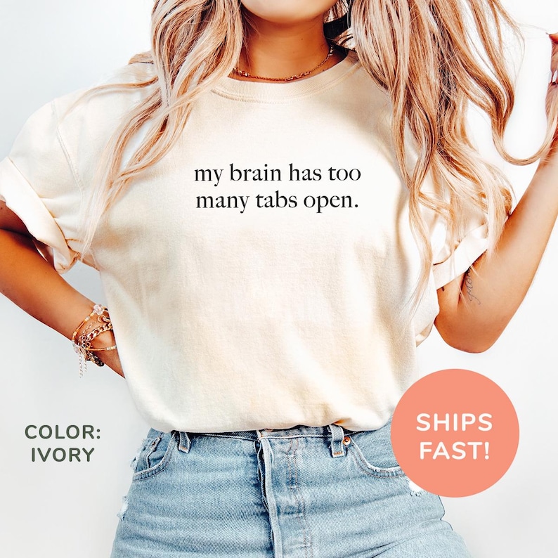 a woman wearing a t - shirt that says, my brain has too many tables