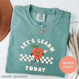 a t - shirt that says let's learn today with an apple on it