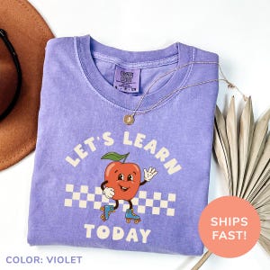 a t - shirt with a picture of an apple on it